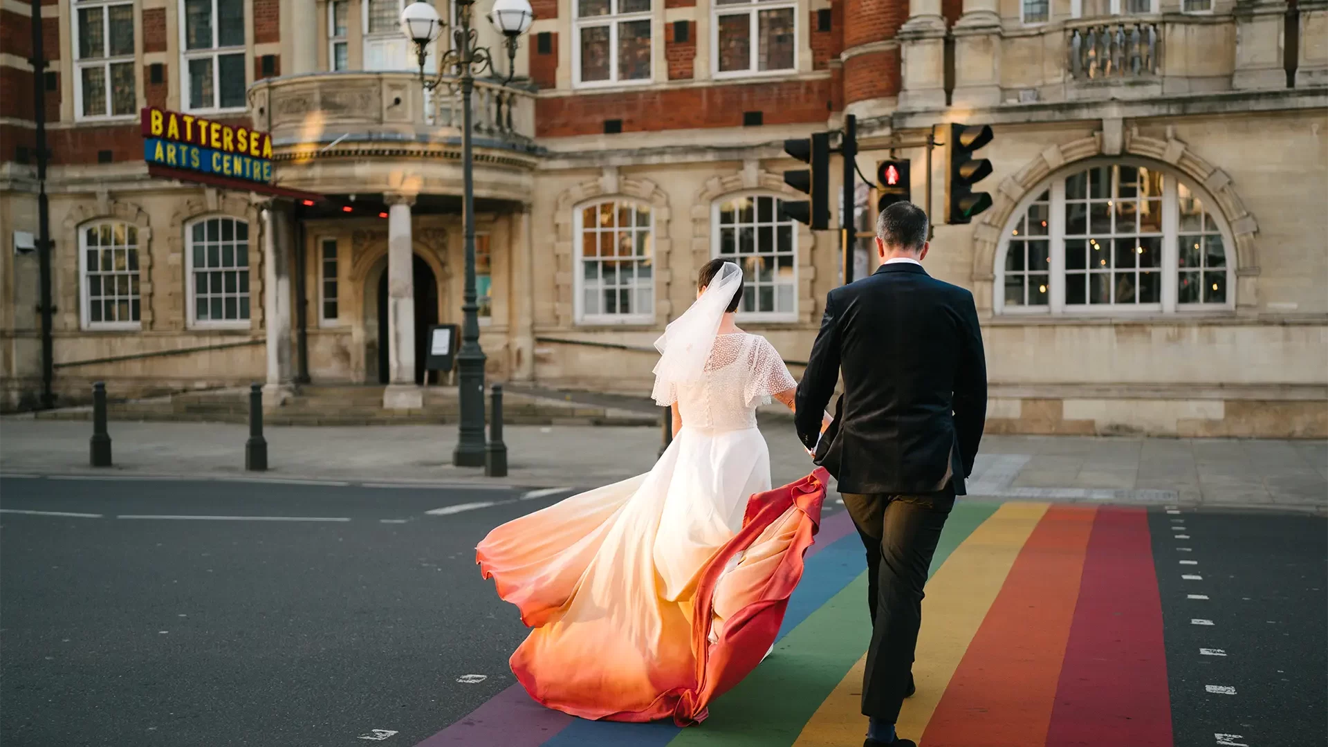 Alexis & Rick walking over rainbow crossing to Battersea Art Centre - Photography by Kari Bellamy
